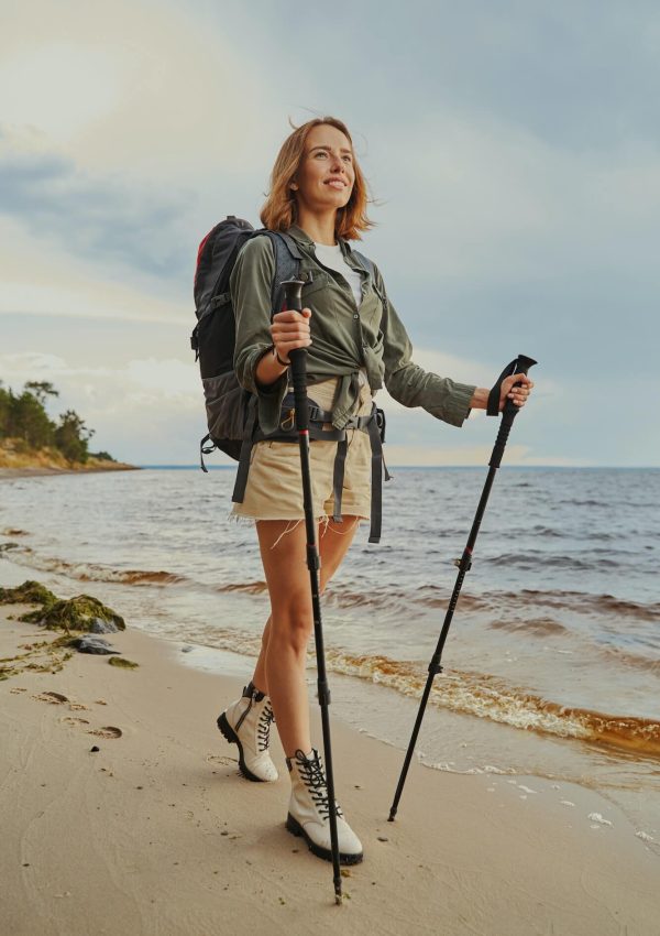 optimistic-traveller-using-walking-poles-during-beach-stroll-1.jpg